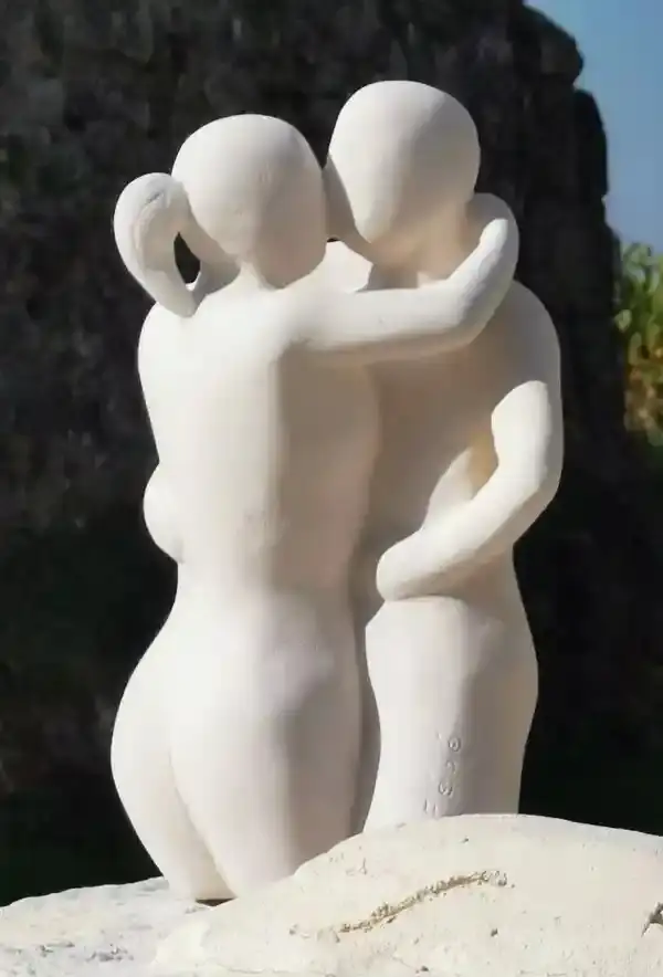 Sculpture en pierre blanche représentant un couple de danseurs vue de côté, réalisée par l’artiste Florence Boutoulle.